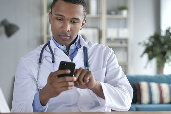 Doctor using smartphone at desk